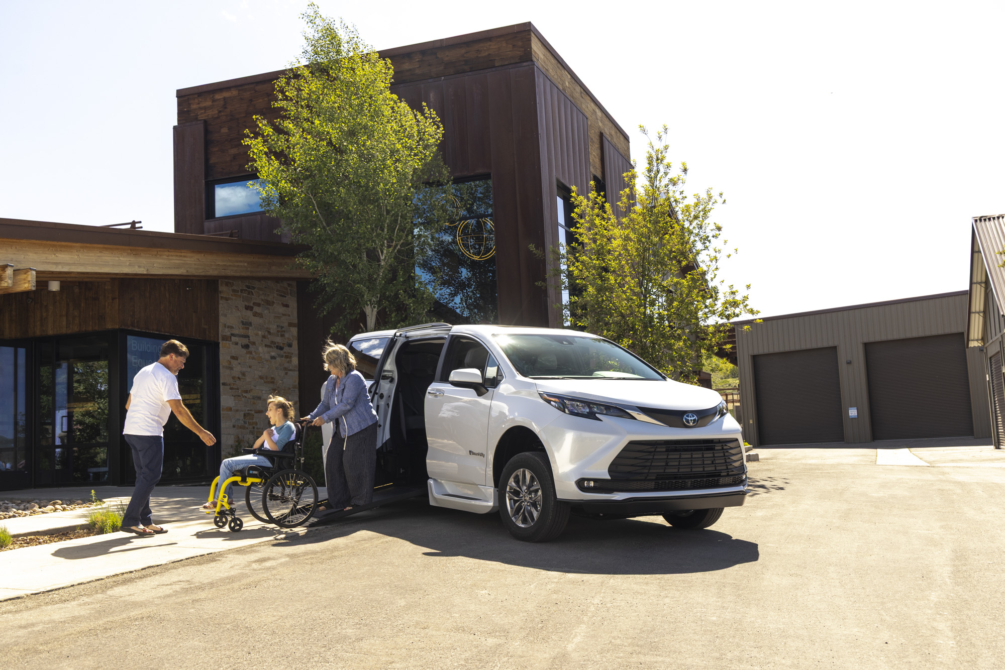 A mobility dealer with a customer at an accessible vehicle